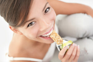 woman eating granola bar